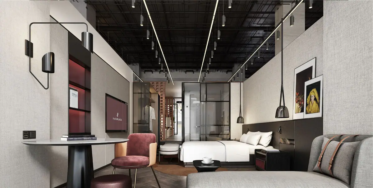 Full-scale hotel guestroom showing furniture, lighting, bathroom and finish coordination