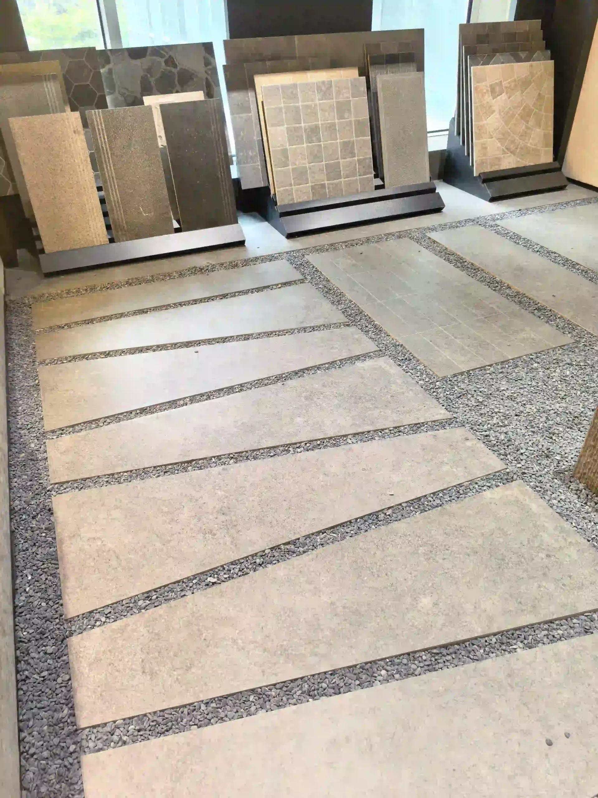 Large outdoor paving stone tile samples displayed with gravel joints